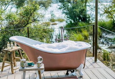 Old Drift Lodge outdoor clawfoot bath Zambezi River views Zimbabwe luxury