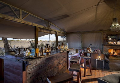 Somalisa Expeditions Camp open bar lounge library fireplace teak deck Hwange Zimbabwe
