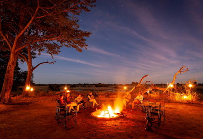 Verney's Camp after-dinner drinks firepit under African stars Hwange Zimbabwe